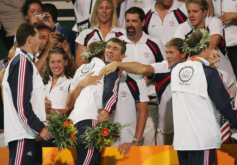 <b>Medal No. 2: </b>Michael Phelps and Lenny Krayzelburg of congratulate Ian Crocker and Jason Lezak of the United States relay team that won the gold medal and set a new world record of 3:30.68 in the men's swimming 4x100 meter medley relay. It's the only medal Phelps claimed for racing in the prelims.