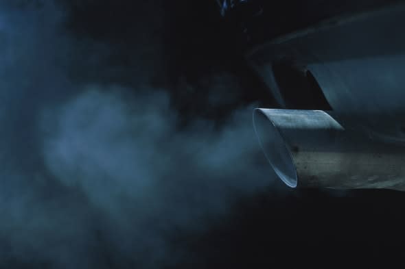 a exhaust pipe of a car emitting fumes