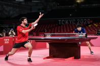 <p>Germany's Dimitrij Ovtcharov serves to Taiwan's Lin Yun-ju during the men's singles table tennis match for the bronze medal at the Tokyo Metropolitan Gymnasium during the Tokyo 2020 Olympic Games in Tokyo on July 30, 2021. (Photo by JUNG Yeon-je / AFP) (Photo by JUNG YEON-JE/AFP via Getty Images)</p> 