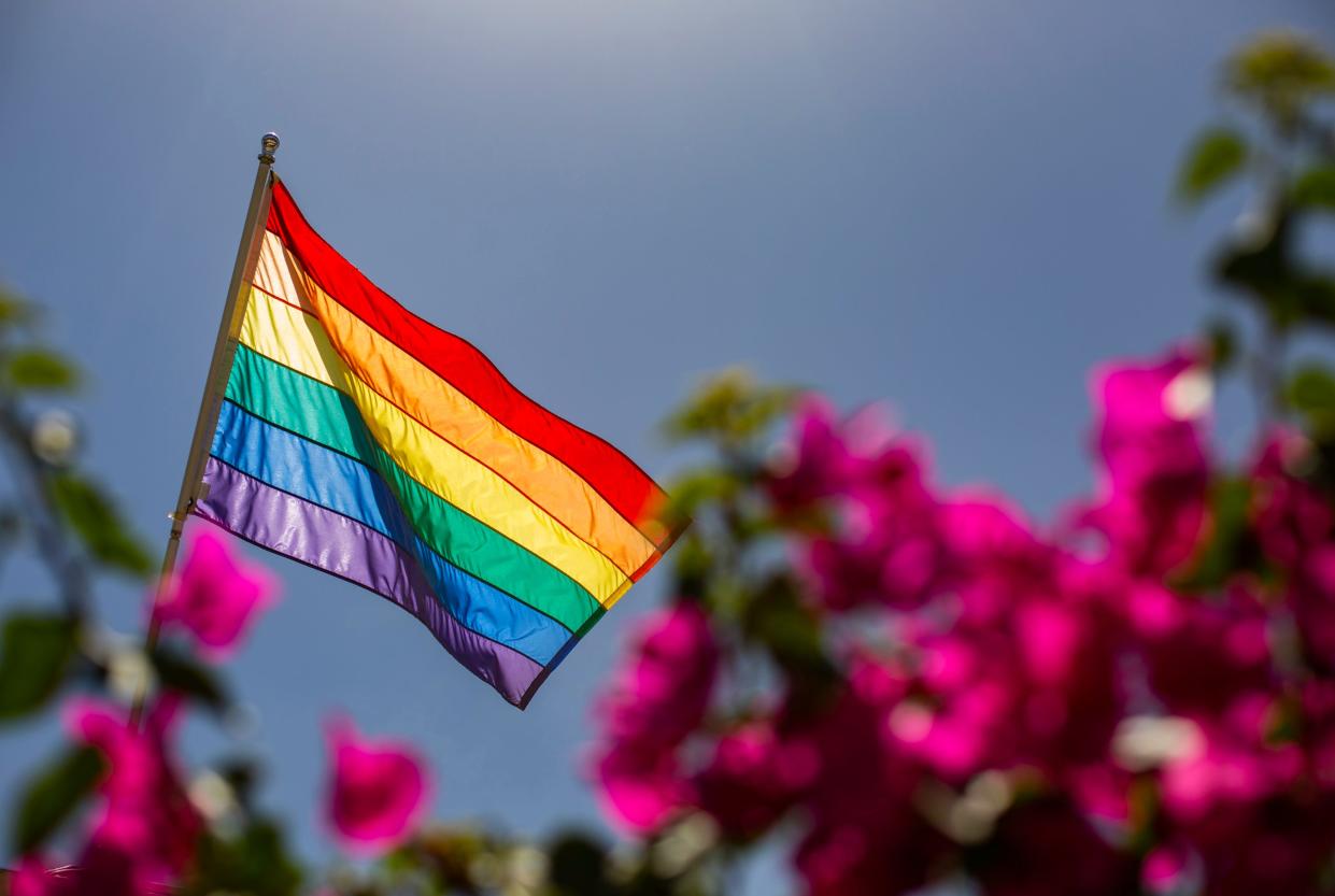A pride flag is seen flying over businesses on Arenas Road in Palm Springs, Calif., Thursday, June 16, 2022. 