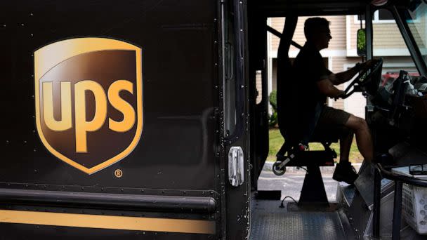 PHOTO: United Parcel Service driver Hudson de Almeida steers through a neighborhood while delivering packages, June 30, 2023, in Haverhill, Mass. (Charles Krupa/AP)