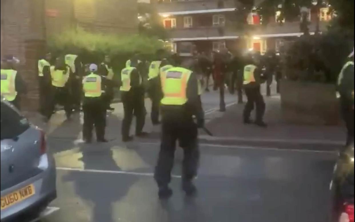 Officers were driven out of an estate in west London by a crowd of people throwing projectiles - TWITTER