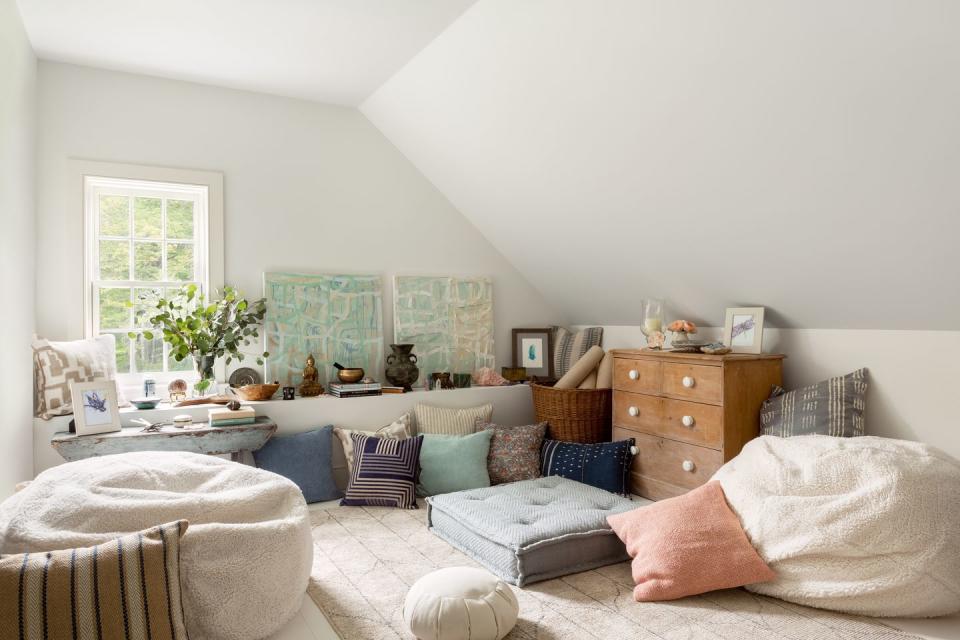 a meditation room with a lot of throw pillows