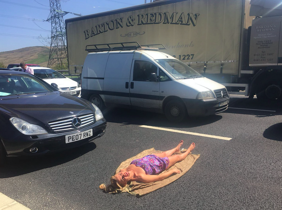 Lily Willetts sunbathing on the M62 on Saturday (Picture: Caters)