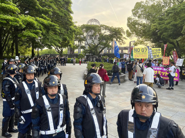 Police outnumber protesters at a rally against the G-7 being held next to the Atomic Bomb Dome war memorial, ahead of the group's meeting in Hiroshima, western Japan, on Wednesday, May 17, 2023. The G-7 summit starts Friday. (AP Photo/Adam Schreck)