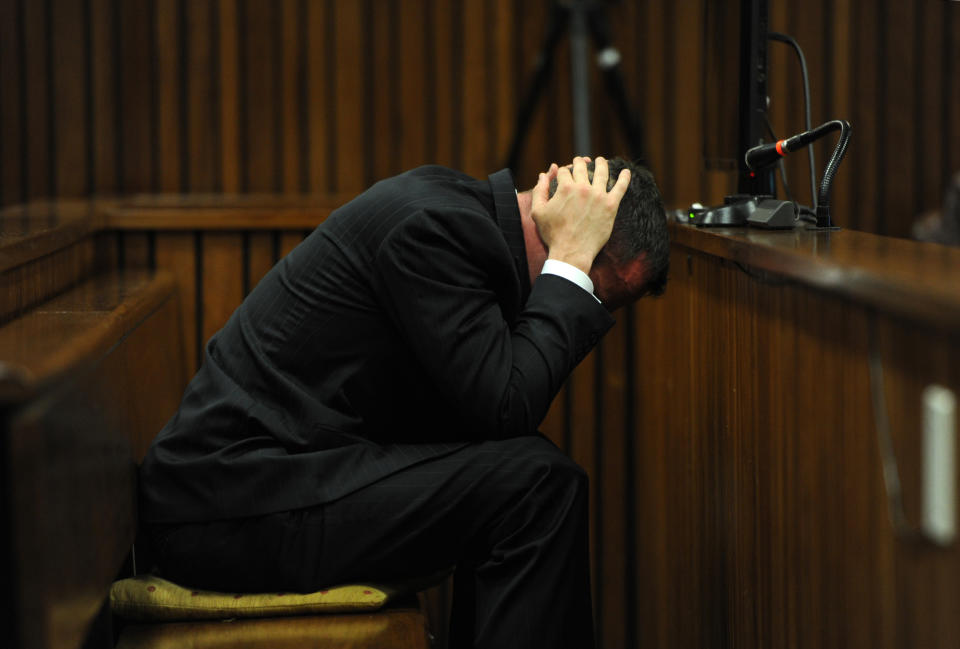 Oscar Pistorius reacts as he listens to forensic evidence being given in court in Pretoria, South Africa, Wednesday, April 16, 2014. Pistorius is charged with the murder of his girlfriend, Reeva Steenkamp, on Valentines Day in 2013. (AP Photo/Werner Beukes, Pool)