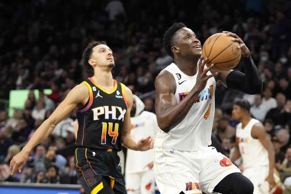 Miami Heat guard Victor Oladipo (4) drives to the basket as Phoenix Suns guard Landry Shamet (14) arrives late during the first half of an NBA basketball game in Phoenix, Friday, Jan. 6, 2023. (AP Photo/Ross D. Franklin)