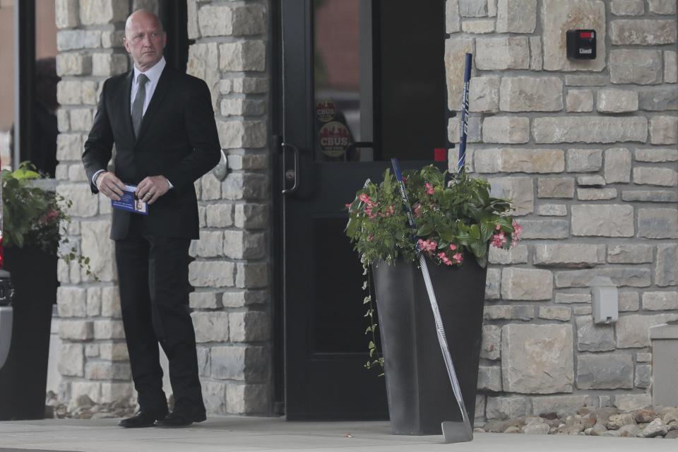 Blue Jackets Jarmo Kekalainen leaves a memorial service for Matiss Kivlenieks on Thursday.