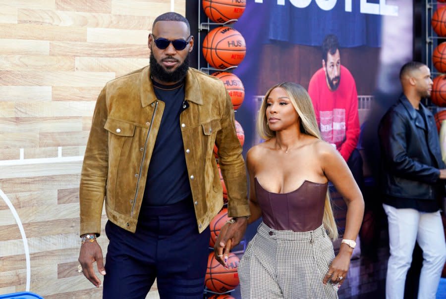 NBA basketball player LeBron James, a producer of the Netflix film “Hustle,” and his wife Savannah arrive at the premiere of the film, Wednesday, June 1, 2022, at the Regency Village Theatre in Los Angeles. (AP Photo/Chris Pizzello)