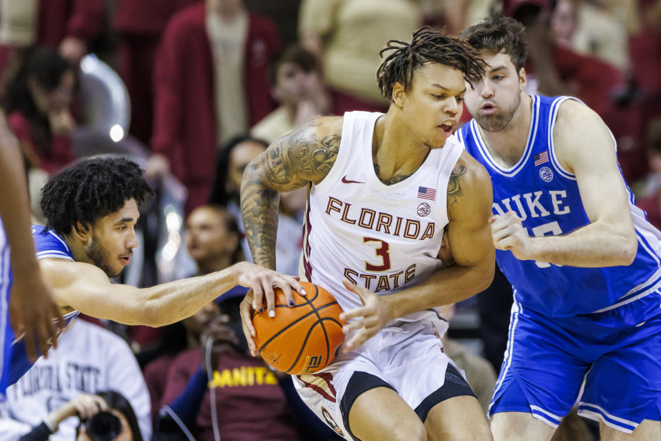 Florida State forward Cam Corhen (3) tries to battle past Duke's Jared McCain (0) left, and Ryan Young (15) during the first half of an NCAA college basketball game, Saturday, Feb. 17, 2024, in Tallahassee, Fla. Duke prevailed over Florida State 76-67. (AP Photo/Colin Hackley)
