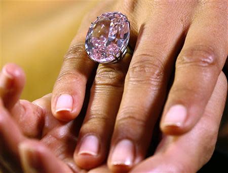 A model displays the 'Pink Star' 59.60 carat oval cut pink diamond at Sotheby's in Geneva September 25, 2013. REUTERS/Ruben Sprich