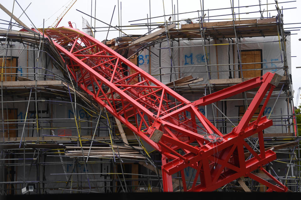 Emergency personnel at the scene in Bow, east London, where a 20-metre crane has collapsed on to a house leaving people trapped inside.