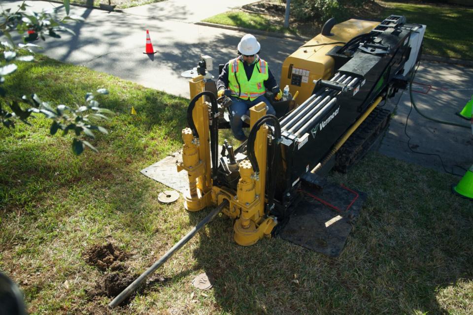 A Comcast contractor uses equipment to install fiber lines in the Kingwood community. At least one thousand miles of new fiber lines will be installed to reach up to 80,000 homes and businesses by the end of 2023.