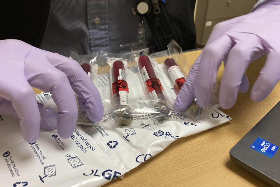 Vials of blood from a participant in a clinical study of the effectiveness of a new liquid biopsy technology are packaged for shipment at Oregon Health & Science University in Portland, Ore., on March 14, 2022. The clinical trial will follow hundreds of participants for three years to see if signals of any cancers that participants later develop were present in their blood. (AP Photo/Gillian Flaccus)