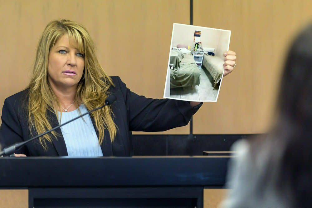 In this April 30, 2019, file pool photo, Karen Herzog, a Florida Department of Health inspector, shows a photo she took of beds in a room during her inspection of Orchids of Asia Day Spa, during a motion hearing in the Robert Kraft prostitution solicitation case in West Palm Beach, Fla. (Lannis Waters/The Palm Beach Post via AP, Pool, File)