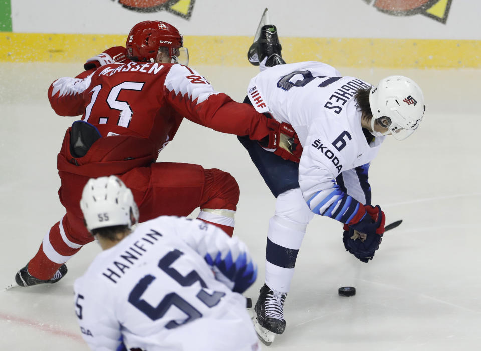 Denmark's Matias Lassen, left, challenges Jack Hughes of the US, right, during the Ice Hockey World Championships group A match between Denmark and the United States at the Steel Arena in Kosice, Slovakia, Saturday, May 18, 2019. (AP Photo/Petr David Josek)