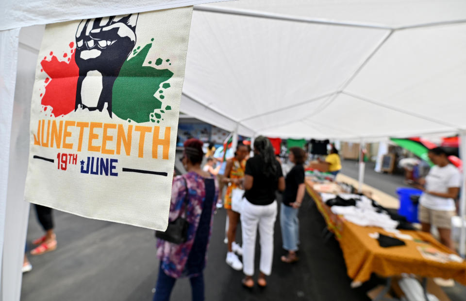 A Juneteenth flag hangs on one of the vendor tents during a Juneteenth celebration. / Credit: Aimee Dilger/SOPA Images/LightRocket via Getty Images