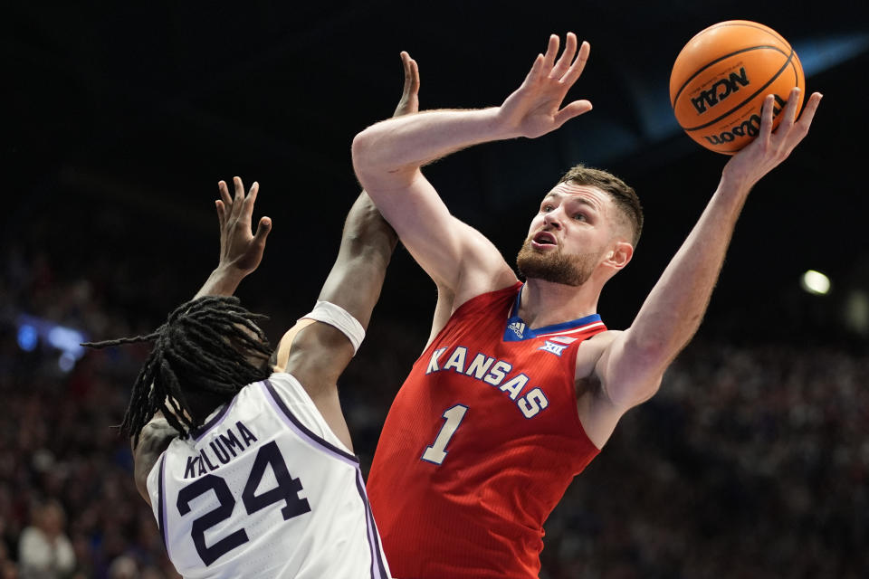 Kansas center Hunter Dickinson (1) shoots under pressure from Kansas State forward Arthur Kaluma (24) during the first half of an NCAA college basketball game Tuesday, March 5, 2024, in Lawrence, Kan. (AP Photo/Charlie Riedel)