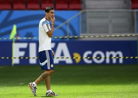 Argentina's national soccer player Angel Di Maria walks onto the pitch for a team training session at the national stadium in Brasilia July 4, 2014, one day before their 2014 World Cup quarter-final soccer match against Belgium. REUTERS/Dylan Martinez