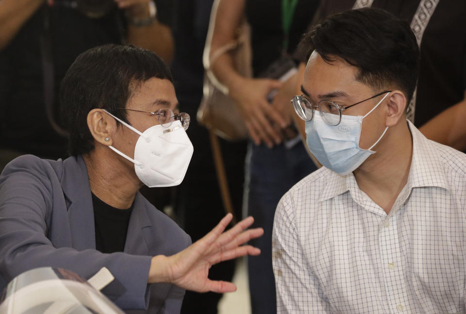 Rappler CEO and Executive Editor Maria Ressa, left, talks with former Rappler reporter Reynaldo Santos Jr., right, during a press conference in Manila, Philippines on Monday June 15, 2020. Ressa, an award-winning journalist critical of the Philippine president, her online news site Rappler Inc. and Santos were convicted of libel and sentenced to jail Monday in a decision called a major blow to press freedom in an Asian bastion of democracy. (AP Photo/Aaron Favila)