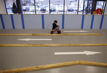 Four-year-old Iori Hiyama rides a tricycle at an indoor playground which was built for children and parents who refrain from playing outside because of concerns about nuclear radiation in Koriyama, west of the tsunami-crippled Fukushima Daiichi nuclear power plant, Fukushima prefecture February 27, 2014. REUTERS/Toru Hanai