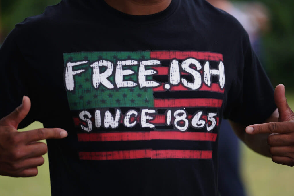 A man displays a shirt celebrating the freedom of enslaved Black people during the Juneteenth celebration in the Greenwood District on June 19, 2020 in Tulsa, Oklahoma.
