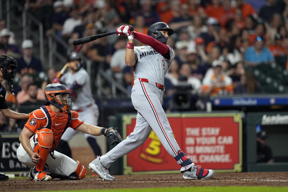 Minnesota Twins' Trevor Larnach (9) hits a two-run home run as Houston Astros catcher Yainer Diaz watches during the fifth inning of a baseball game Friday, May 31, 2024, in Houston. (AP Photo/David J. Phillip)