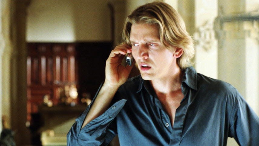Barry Pepper holding a phone