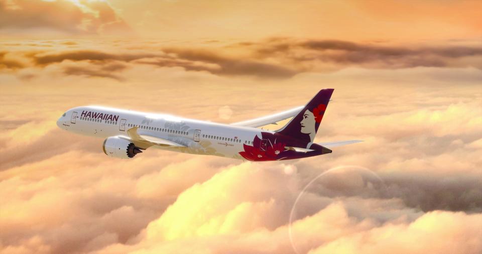 Hawaiian Airlines' Boeing 787-9 Dreamliner flying during golden hour.