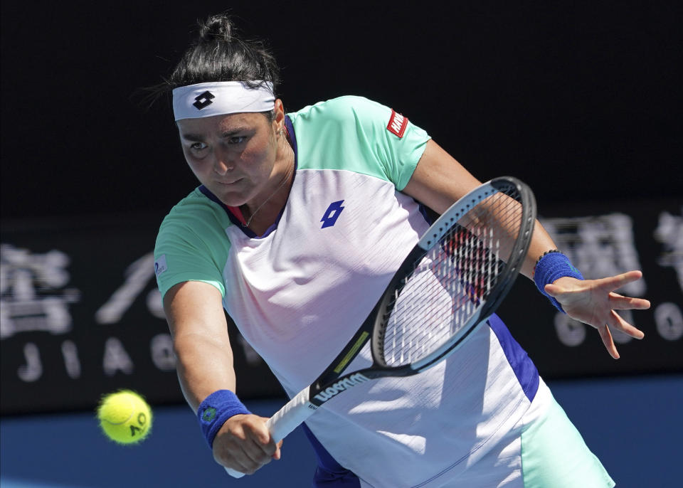 Tunisia's Ons Jabeur makes a backhand return to Sofia Kenin of the U.S. during their quarterfinal match at the Australian Open tennis championship in Melbourne, Australia, Tuesday, Jan. 28, 2020. (AP Photo/Lee Jin-man)