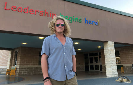 Zachary Dearing stands outside an elementary school which was used as an evacuation center during Hurricane Harvey last year in Rockport, Texas, May 29, 2018. Photo taken May 29, 2018. REUTERS/Jon Herskovitz