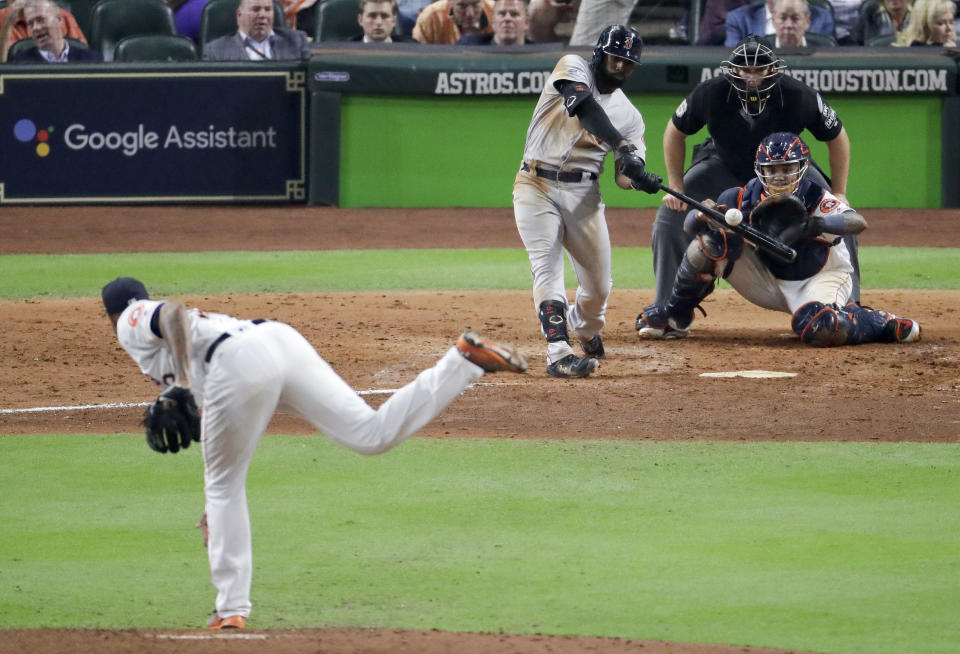 FILE - Boston Red Sox's Jackie Bradley Jr., hits a two-run home run off Houston Astros pitcher Josh James during the sixth inning in Game 4 of a baseball American League Championship Series in Houston, in this Wednesday, Oct. 17, 2018, file photo. Major League Baseball wants to see if moving back the pitcher's mound will increase offense. MLB will experiment with a 12-inch greater distance between the mound and home plate during a portion of the Atlantic League season in an effort to decrease strikeouts and increase offense. The pitching rubber will be moved back to 61 feet, 6 inches starting Aug. 3. (AP Photo/Lynne Sladky, File)