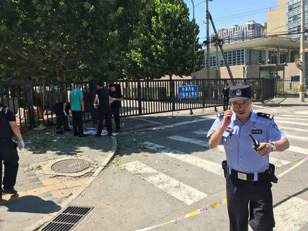 A police officer is seen near the U.S. embassy in Beijing, China July 26, 2018. REUTERS/ Thomas Peter