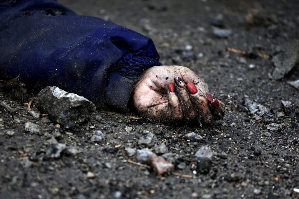 The hand of Iryna Filkina, a woman who according to residents was killed by Russian army soldiers, is pictured as her body lies on the street, after Russia invaded Ukraine (Reuters)