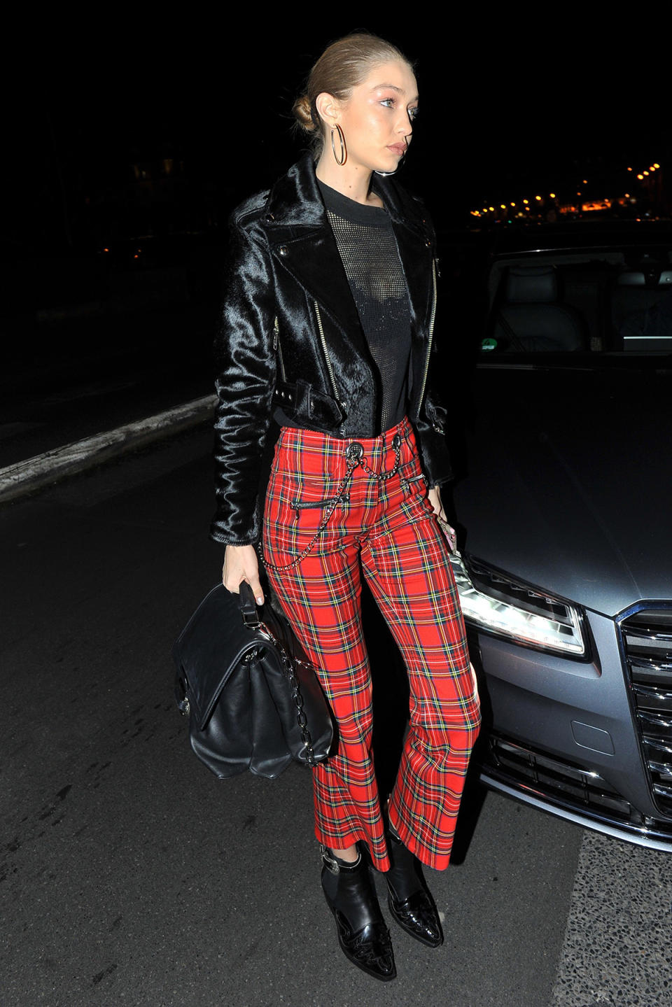 <p>Supermodel Gigi Hadid wore a sheer top with <a rel="nofollow noopener" href="https://miaouxx.com/collections/denim/products/morgan-plaid" target="_blank" data-ylk="slk:$325 plaid pants;elm:context_link;itc:0;sec:content-canvas" class="link ">$325 plaid pants</a> from Miaou at a “V Magazine” party in March 2017. She completed the look with a fur moto jacket. (Photo: AKM-GSI) </p>