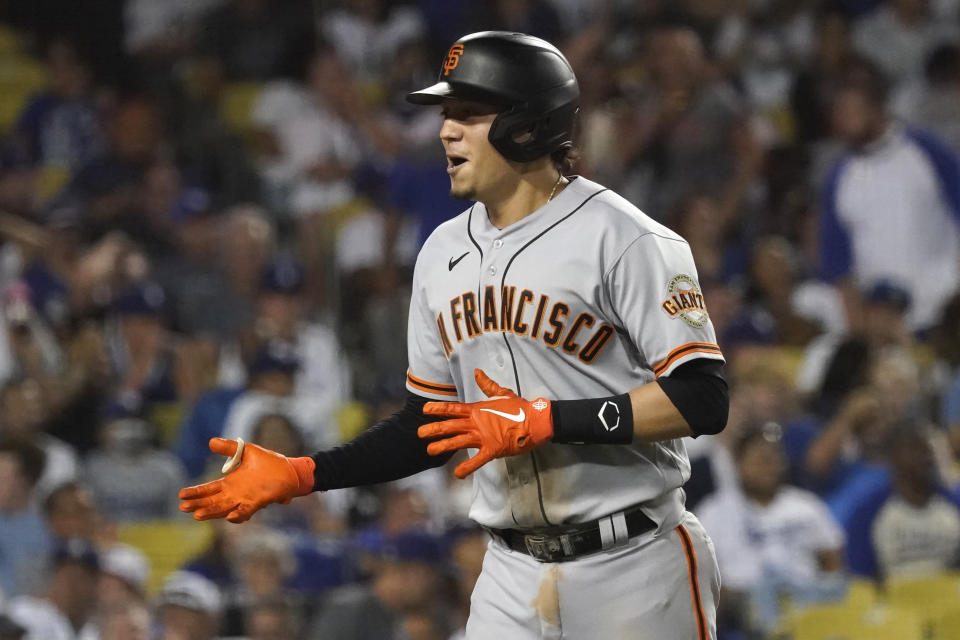 San Francisco Giants' Wilmer Flores celebrates his two-run home run during the ninth inning of the team's baseball game against the Los Angeles Dodgers on Wednesday, July 21, 2021, in Los Angeles. (AP Photo/Marcio Jose Sanchez)