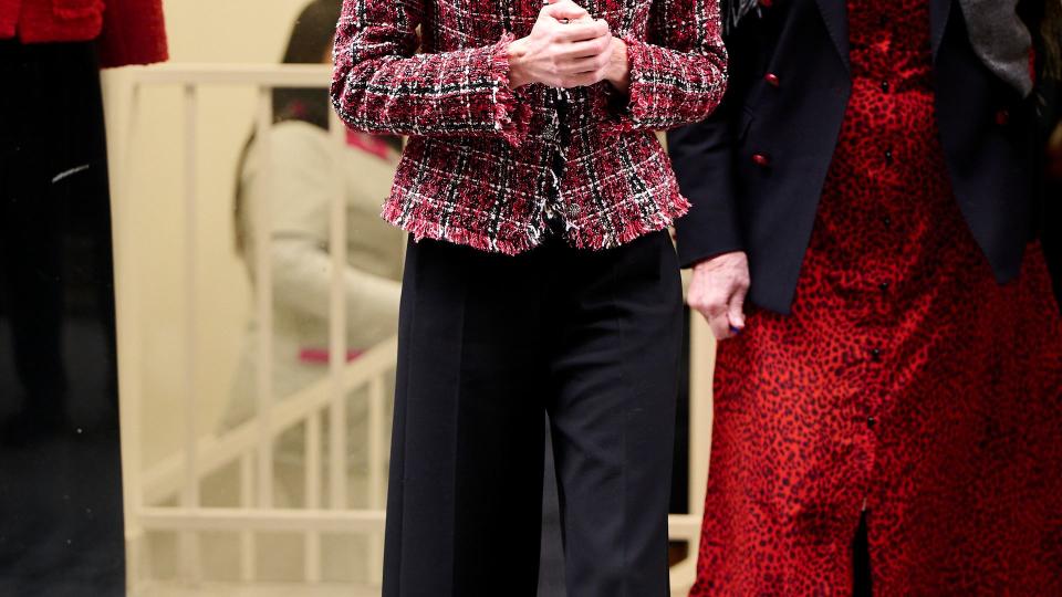 ueen Letizia of Spain visits the central headquarters of the Association for the Prevention, Reintegration in a custom-made jacket with black trousers and ballet flats