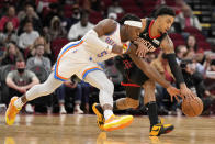 Oklahoma City Thunder forward Luguentz Dort (5) and Houston Rockets forward Kenyon Martin Jr. chase a loose ball during the first half of an NBA basketball game, Monday, Nov. 29, 2021, in Houston. (AP Photo/Eric Christian Smith)