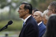 Darrell Issa, center, speaks during a news conference Thursday, Sept. 26, 2019, in El Cajon, Calif. Issa, a former congressman, announced he will attempt a return to Congress to replace fellow Republican and longtime-U.S. Rep. Duncan Hunter, who is running for re-election while under indictment on corruption charges. (AP Photo/Gregory Bull)