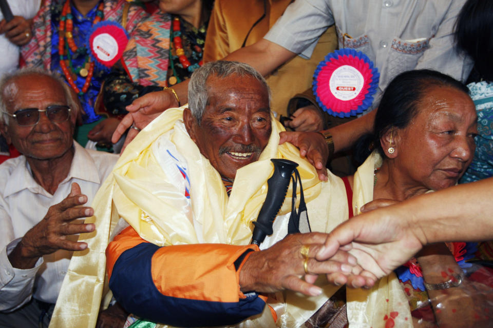 FILE - In this May 31, 2008 file photo, Min Bahadur Sherchan, center, who became the oldest person to climb Mount Everest on May 25, 2008 shakes hands on his arrival in Katmandu, Nepal. Yuichiro Miura, an 80-year-old Japanese extreme skier who just missed becoming the oldest man to reach the summit of Mount Everest five years ago is back on the mountain to make another attempt at the title. Unfortunately for Miura, Sherchan, the slightly older man who nabbed the record a day before he could in 2008 is fast on his heels. (AP Photo/Binod Joshi, File)