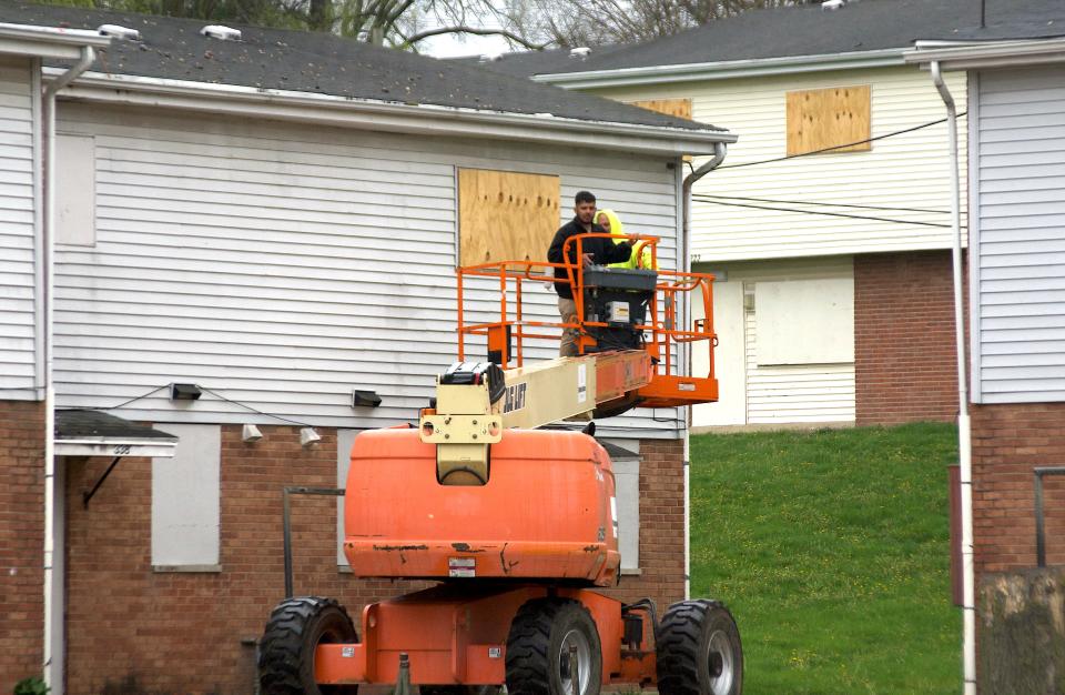 A Rockford Housing Authority crew boards up a window Wednesday, April 17, 2024, at the now vacant Fairgrounds Valley housing complex on the city's near west side.