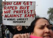 Demonstrators shout slogans and wave placards as they move towards India Gate in New Delhi, on December 27, 2012, during a protest calling for better safety for women, following the rape of a student in the Indian capital