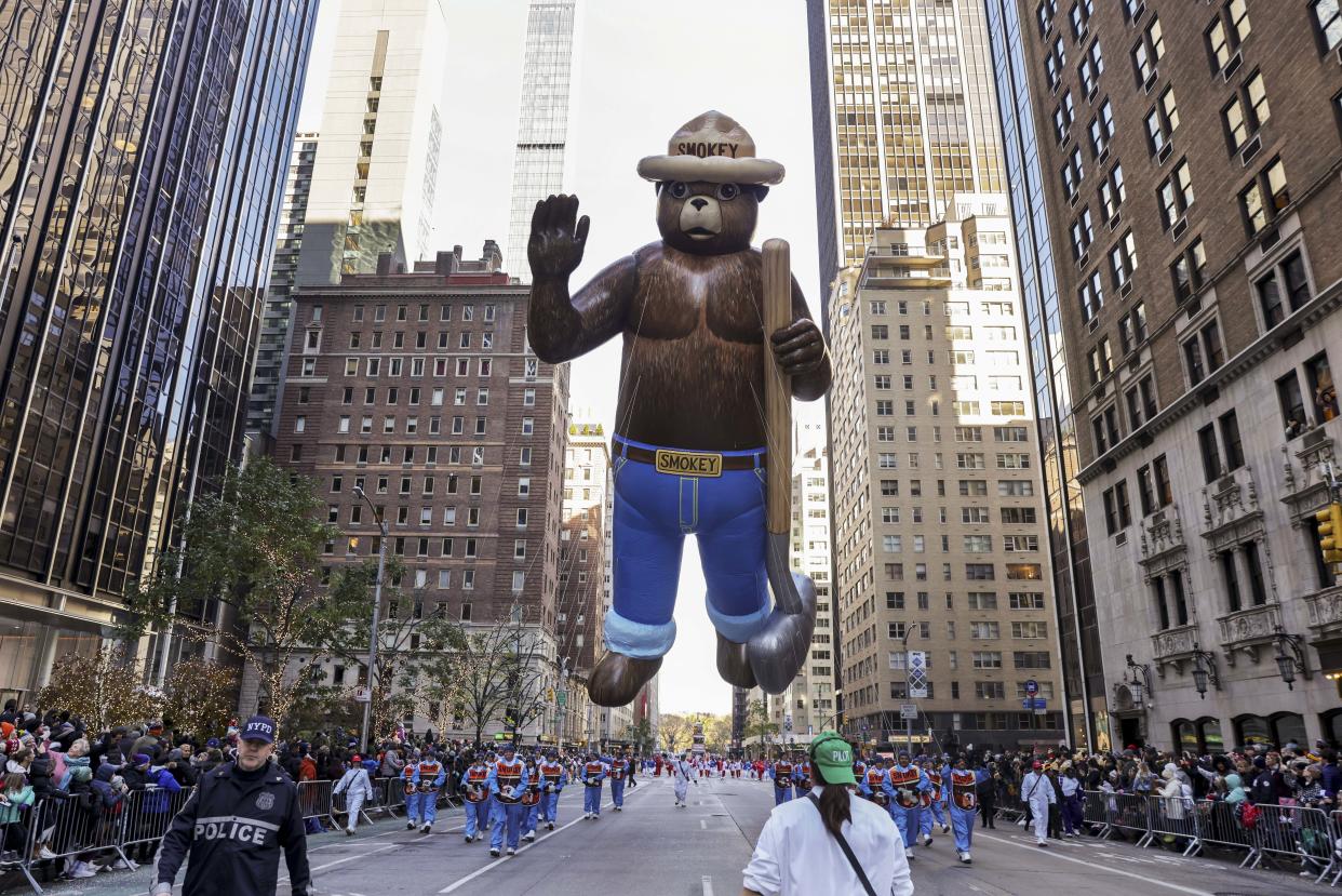 Handlers pull the Smokey Bear balloon down Sixth Avenue, a regular fixture during the Macy's Thanksgiving Day Parade. (Jeenah Moon / AP)