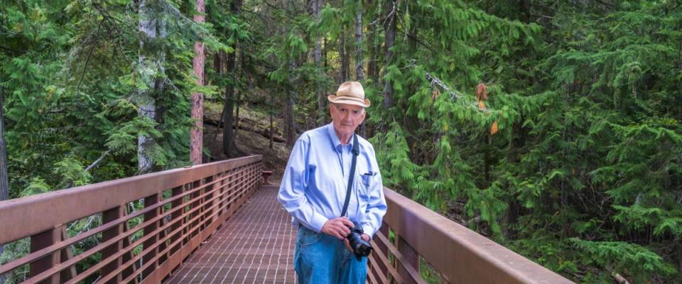 Healthy Active Senior Photographer Hiking Outdoors. Copy space.