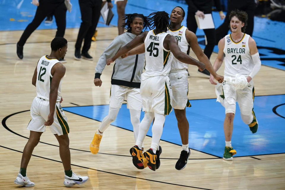 Baylor guard Davion Mitchell (45) celebrates with teammate guard Mark Vital after making a 3-point basket at the end of the first half of a men's Final Four NCAA college basketball tournament semifinal game against Houston, Saturday, April 3, 2021, at Lucas Oil Stadium in Indianapolis. (AP Photo/Michael Conroy)