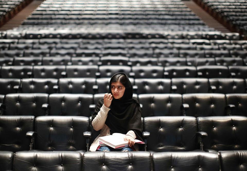 RNPS - PICTURES OF THE YEAR 2013 - Pakistani teenage activist Malala Yousafzai, who was shot in the head by the Taliban for campaigning for girls' education, signs a copy of her book before an event launching her memoir, "I Am Malala", at the Southbank Centre in central London October 20, 2013. REUTERS/Olivia Harris (BRITAIN - Tags: POLITICS EDUCATION TPX)