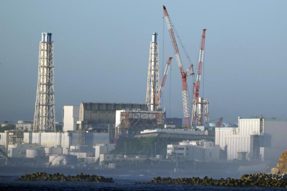 The Fukushima Daiichi nuclear power plant, damaged by a massive March 11, 2011, earthquake and tsunami, is seen from the nearby Ukedo fishing port in Namie town, northeastern Japan, Thursday, Aug. 24, 2023. The Fukushima Daiichi nuclear power plant will start releasing treated and diluted radioactive wastewater into the Pacific Ocean as early as Thursday. (AP Photo/Eugene Hoshiko)
