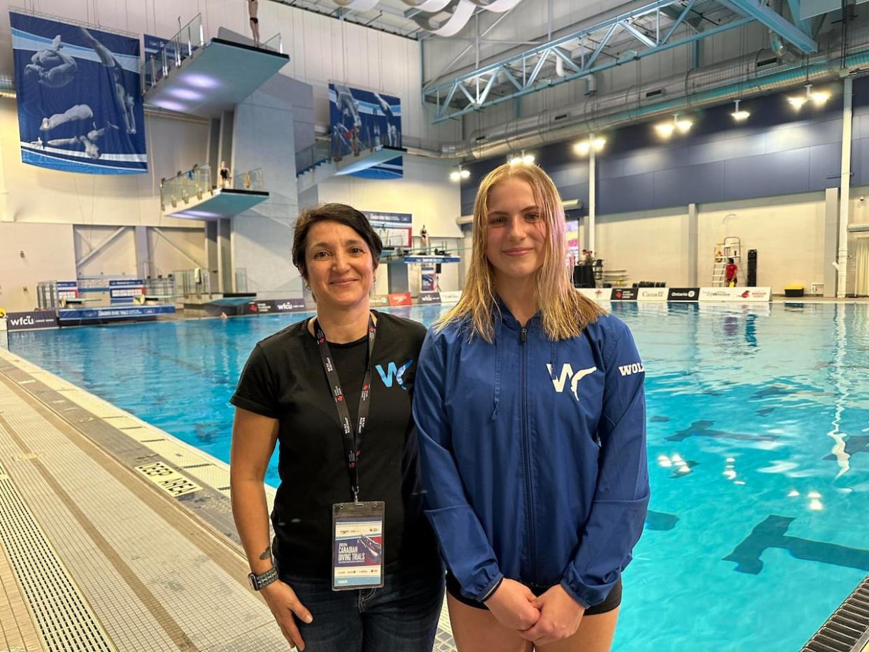 Maisy Woloszyn, 16, pictured right, will comepte at the Canadian Diving Trials in Windsor on May 17.  (Meg Roberts/CBC - image credit)
