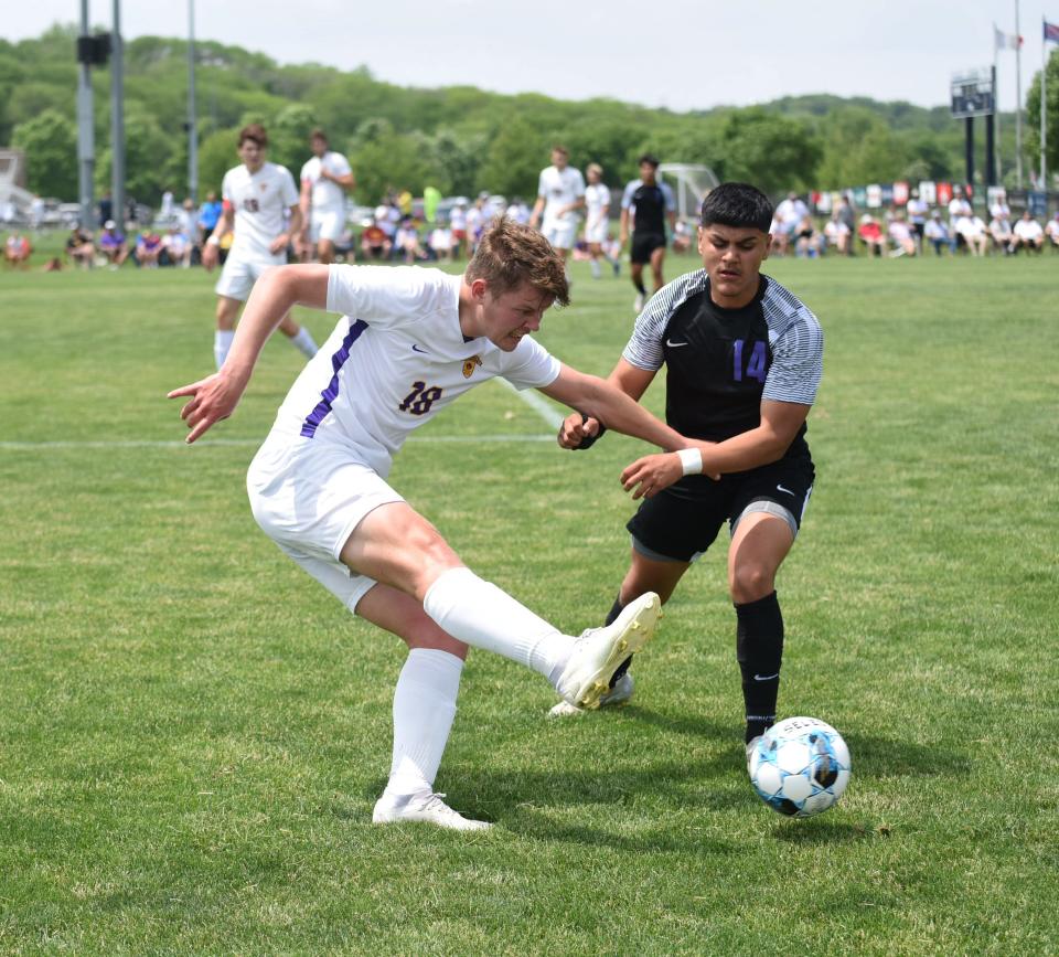 Nevada defender Dylan Fritz clears the ball away from Webster City's Magdiel Magdaleno during the first half of the 2A boys state soccer quarterfinals Tuesday. Nevada advanced to the 2A semifinals with a 1-0 victory.