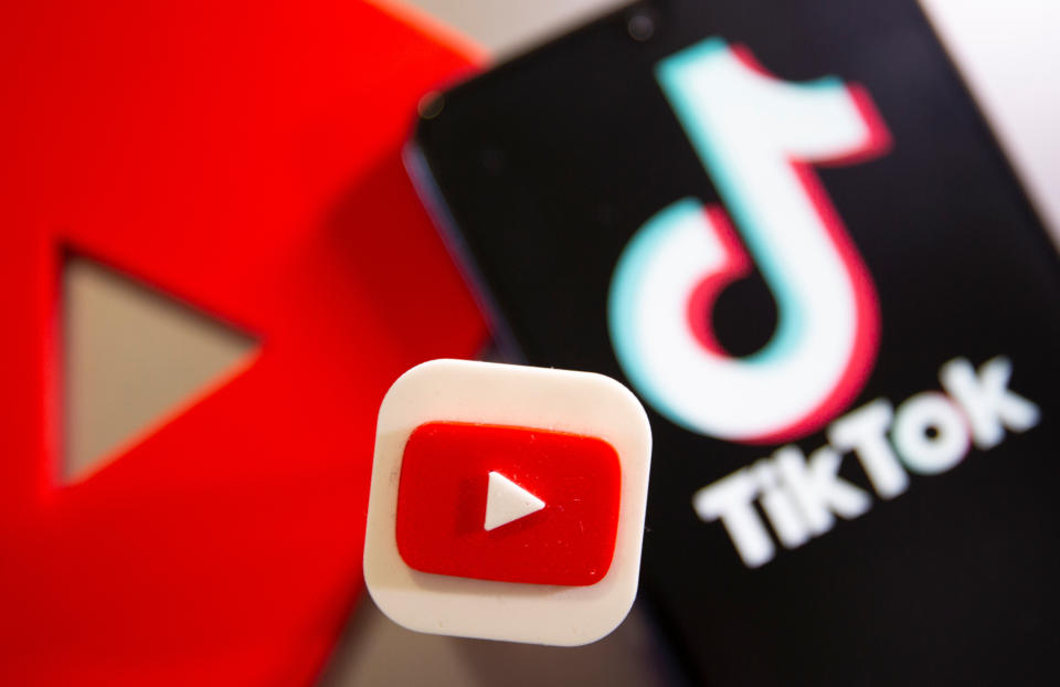 A 3D printed Youtube and Tik Tok logo are seen near smartphone with displayed Tik Tok logo in this illustration taken, September 15, 2020. REUTERS/Dado Ruvic/Illustration